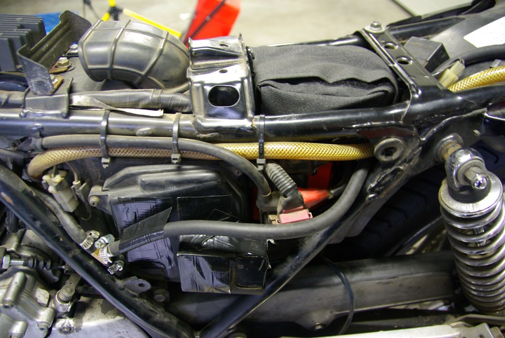 Under the left side cover. Tight.